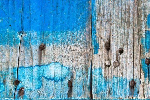 Weathered blue wood with rusty nails as a background