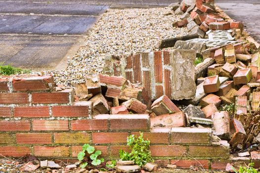 A garden wall which has collapsed