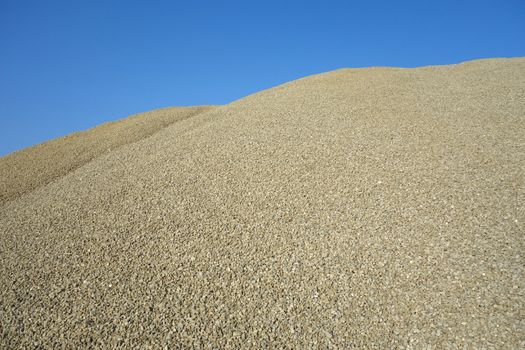 Pile of green gravel - sand, ready to be used as a construction material