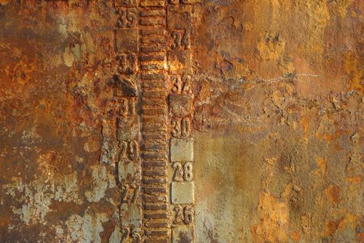 Rusty steal texture of an abandoned tanker boat closeup. Waterline and draft scale measure