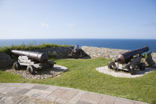 three ancient bronze cannons waterfront in Ribadesella city Asturias Spain Europe