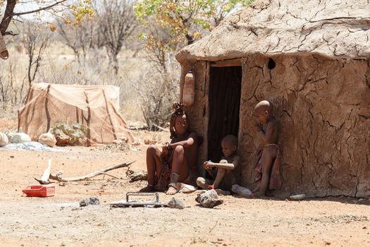 NAMIBIA, KAMANJAB, OCTOBER 10: Himba tribe woman with childs, in the village of Himba people near Kamanjab in northern Namibia, October 10, 2014, Namibia