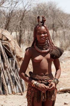 NAMIBIA, KAMANJAB, OCTOBER 10: Himba tribe woman with ornaments on the neck, in the village of Himba people near Kamanjab in northern Namibia, October 10, 2014, Namibia