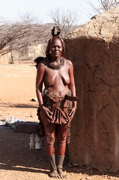 NAMIBIA, KAMANJAB, OCTOBER 10: Himba tribe woman with ornaments on the neck, in the village of Himba people near Kamanjab in northern Namibia, October 10, 2014, Namibia