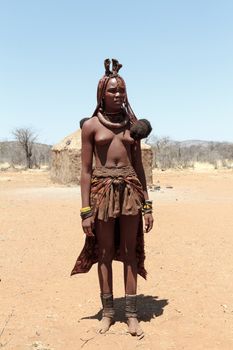 NAMIBIA, KAMANJAB, OCTOBER 10: Himba tribe woman with ornaments on the neck, in the village of Himba people near Kamanjab in northern Namibia, October 10, 2014, Namibia