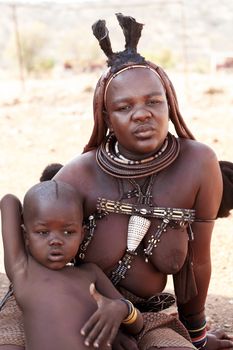 NAMIBIA, KAMANJAB, OCTOBER 10: Himba tribe woman with childs, in the village of Himba people near Kamanjab in northern Namibia, October 10, 2014, Namibia