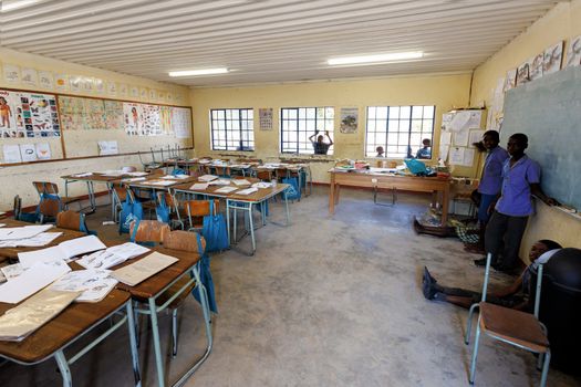 NAMIBIA, KAVANGO, OCTOBER 15: Happy Namibian school children waiting for a lesson. Kavango was the region with the highest poverty level in Namibia, more than 50% of the population were classified as poor. October 15, 2014, Namibia