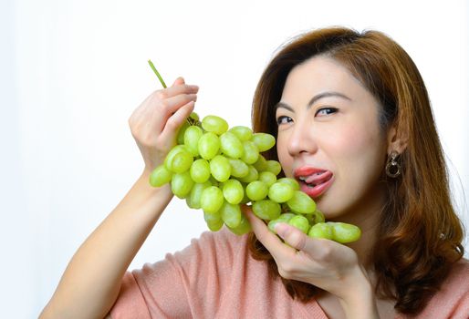 Beautiful asian woman with green grape