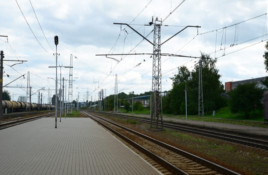 Photo of a railway station platform with electricity transmission system. Taken in Riga, Latvia.