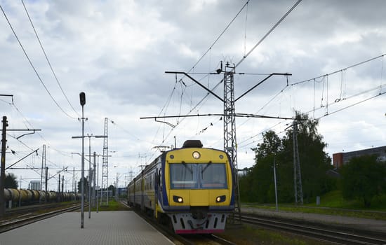 Photo of a train arriving at railway platform. Taken in Riga, Latvia.