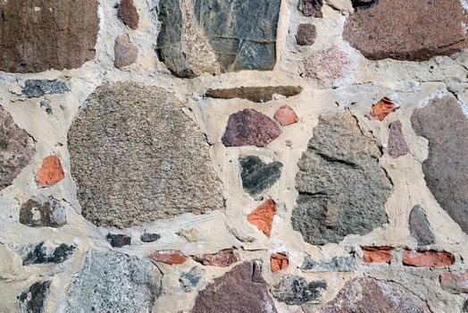 Photo of a colourful stone wall. May be used as a background.