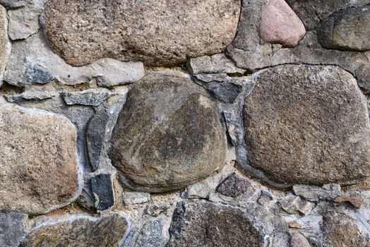 Photo of a granite stone wall. May be used as a background.