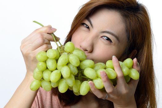 Beautiful asian woman with green grape