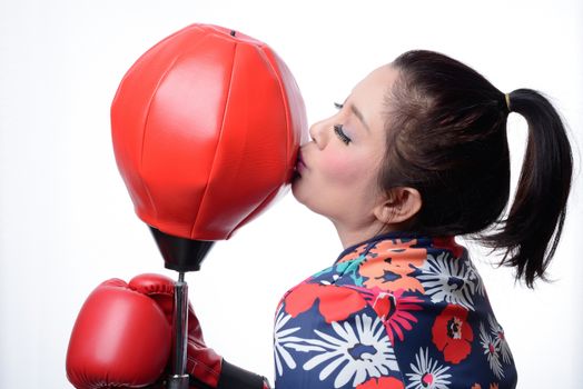 asian boxing woman kiss red punching bag