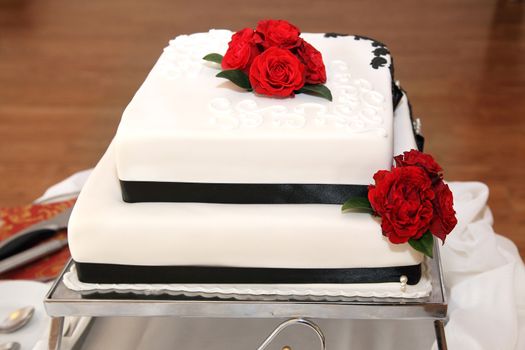 Wedding cake decorated by red roses