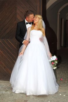 Groom kissing his beautiful wife