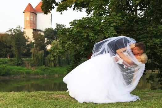 Groom kissing his beautiful wife