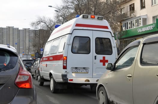 The ambulance car gets stuck in a traffic jam. Tyumen, Russia.