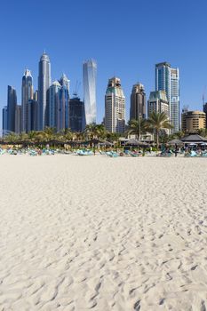 Vertical view of famous skyscrapers and jumeirah beach in Dubai. UAE 