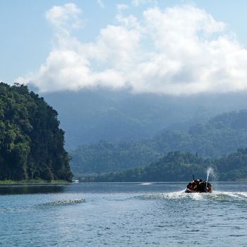 Lake mountain with boat and blue sky