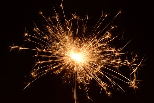 Photo of a Burning christmas sparkler. Object photography.