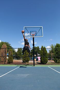 Young basketball player flying to the hoop for a monster jam.