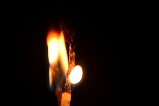 Photo of a match fire isolated on a black background. Objects photography.