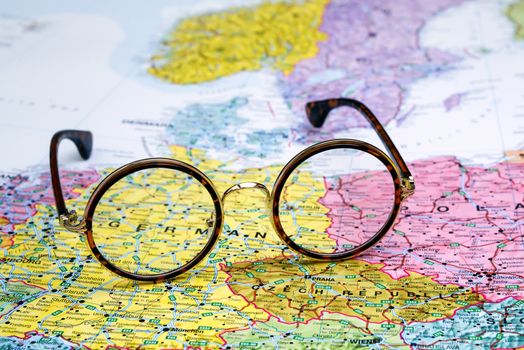 Photo of glasses on a map of europe. Focus on Germany. May be used as illustration for traveling theme.