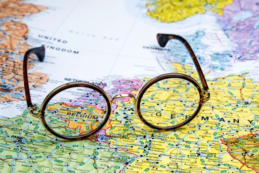 Photo of glasses on a map of europe. Focus on Belgium. May be used as illustration for traveling theme.