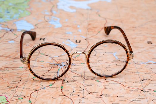 Photo of glasses on a map of europe. Focus on Moscow. May be used as illustration for traveling theme.