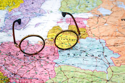 Photo of glasses on a map of europe. Focus on Lithuania. May be used as illustration for traveling theme.