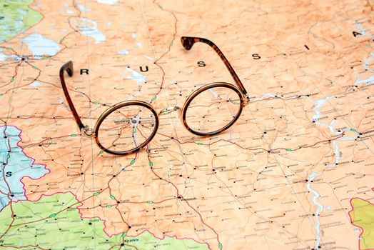 Photo of glasses on a map of europe. Focus on Moscow. May be used as illustration for traveling theme.