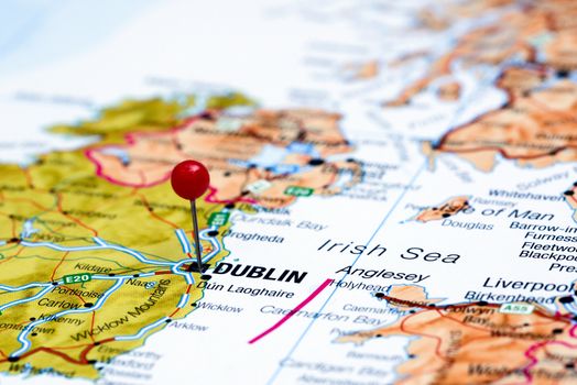 Photo of pinned Dublin on a map of europe. May be used as illustration for traveling theme.