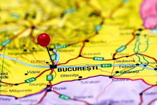 Photo of pinned Bucharest on a map of europe. May be used as illustration for traveling theme.