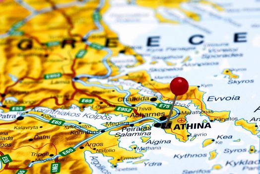 Photo of pinned Athens on a map of europe. May be used as illustration for traveling theme.