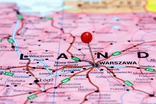 Photo of pinned Warsaw on a map of europe. May be used as illustration for traveling theme.