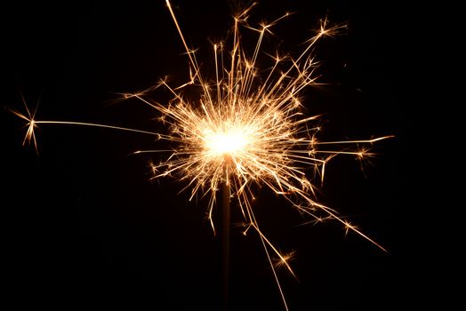 Photo of a burning christmas sparkler on a black background