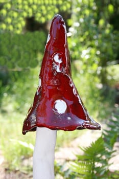 Handmade mushroom with white stem and red cap with white dots 