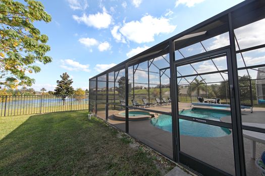 A Swimming Pool and Spa with Screen and Lake View