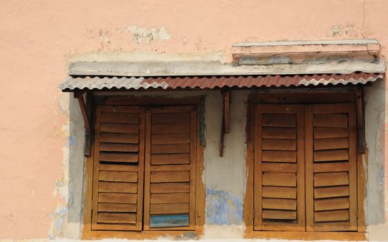 A pair of wooden windows in an ancient building in Ipoh Malaysia