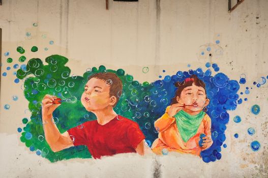 the graffiti of boy and girl blowing bubbles in the backyard