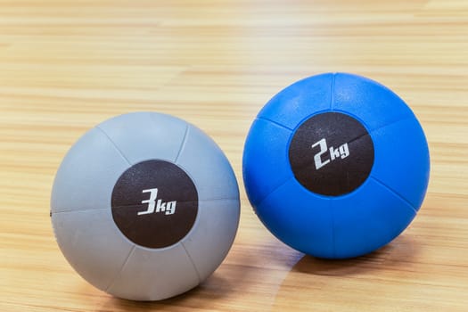 couple of medicine weight ball on wooden floor