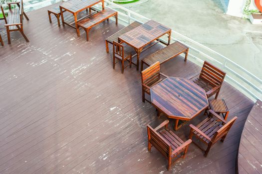 Dining table on terrace beside white fence, top view