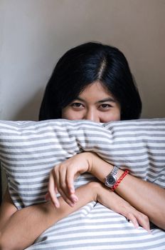 Happy woman holding pillow