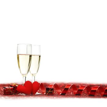 Glasses with Champagne and handmade hearts on red glitters isolated on white background