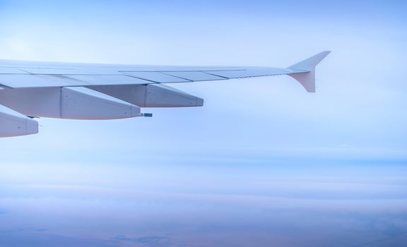 Wing seen through window of an aircraft