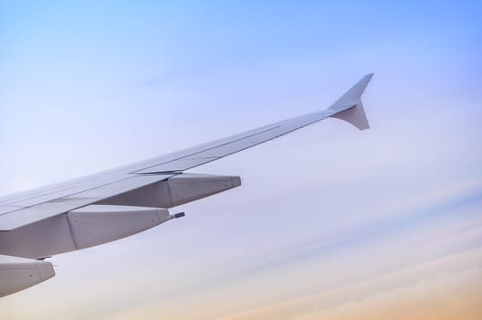Wing seen through window of an aircraft