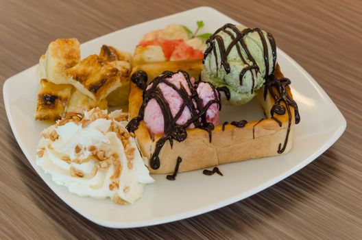 Honey toast and whipping cream with chocolate  sauce and ice cream