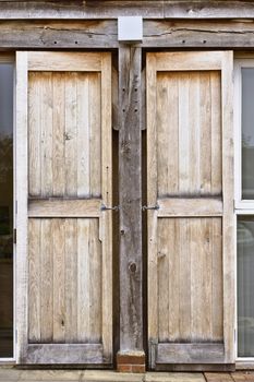 Tall window shutters on a modern wooden eco building