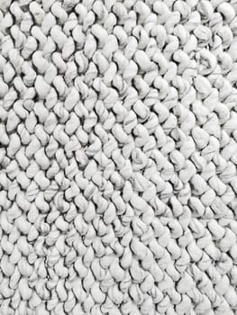 White knitted background. Detail of handmade rug.